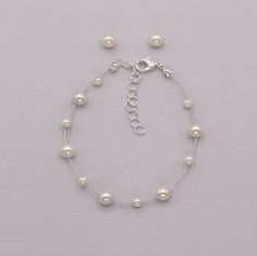 "Perfect for that adorable little girl, this bracelet and earrings set features white or ivory glass pearls that \"float\" with beauty, and matching stud pearl earrings.  DETAILS * High quality glass pearls (white or ivory), hand-strung.  * Stud earrings measure 6mm (pierced or clip-ons). * Optional necklace is adjustable from 12\"-15\" long. * Bracelet is adjustable from 6 1/2\"-8\" long * Perfect as a gift, junior bridesmaids, flower girl or First Communion, or any special occasion.  * Finish: silver. * Hypoallergenic, lead-free & nickel-free. ADDITIONAL LENGTH WITH EXTENDER * Necklace extender available here: https://www.etsy.com/listing/1527588142/extender-for-necklace-clasp-extender?ref=listings_manager_grid * Bracelet extender available here: https://www.etsy.com/listing/924281952/ne Flower Girl Jewelry Set, Bracelet Extender, Bracelet Matching, Flower Girl Jewelry, Pretty Jewelry Necklaces, Necklace Extender, Earrings Flower, Matching Colors, Girl Jewelry