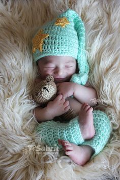 a baby is sleeping with a stuffed animal