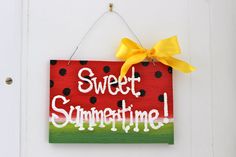 a wooden sign hanging on the side of a white door that says sweet summertime