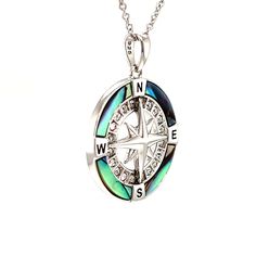 This necklace is the perfect gift for an adventurous sea lover. Crafted in sterling silver, this beautiful necklace features a compass pendant with a 3D 8 points rose in the center. Twenty white crystals have been set in the inner circle to highlight the wind rose. The outer circle has been decorated with stunning Abalone shell. The shell contrasts beautifully with the four black letters that represent the cardinal points. This beautiful necklace is completed by a plain bail and an adjustable st Luxury Sterling Silver Compass Design Jewelry, Luxury Sterling Silver Jewelry With Compass Design, Sterling Silver Compass Necklace For Travel, Sterling Silver Compass Design Necklace For Travel, Luxury Silver Jewelry With Compass Design, Luxury Silver Compass Design Jewelry, Luxury Silver Jewelry For Travel, Sterling Silver Round Pendant Jewelry For Travel, Elegant Silver Jewelry For Travel