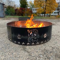 a fire pit is shown with flames in the center and paw prints painted on it