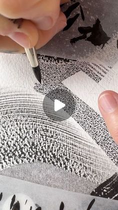 someone is drawing on paper with a pen and inking the image in black and white