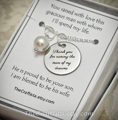 This elegant piece of jewelry will make a beautiful and sentimental gift that will best express your gratitude and love for your groom's mom. This necklace has been featured in a Treasury List, see last photo.This piece includes:8mm authentic shell pearl pendant  and a 20mm disc pendant engraved with the words "Thank you for raising the man of my dreams." The charms dangle from a silver-plated 18-inch chain.Gift Card reads:You raised with love this gracious man with whom I'll spend my life.He is Mother Of The Groom Jewelry, Grooms Mom, The Man Of My Dreams, Man Of My Dreams, Mother Of The Groom Gift, Mother Of The Groom Gifts, Mother In Law Gifts, In Law Gifts, Inexpensive Gift