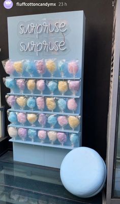 there is a display case that has cotton candy in the shape of cupcakes