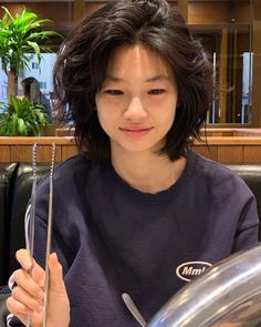 a woman sitting at a table with a fork in her hand