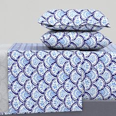 three blue and white sheets stacked on top of each other