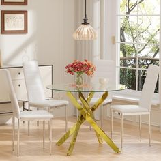 a glass table with yellow tape around it and flowers in the vase at the base