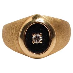 The 14k Yellow Gold European Cut Natural Diamond Cocktail Ring Circa 1950s is a breathtaking piece that captures the essence of mid-century glamour. Featuring an elegant oval setting with a striking European-cut diamond, this ring is distinguished by its unique black background behind the diamond, which enhances the stone's brilliance and creates a dramatic contrast against the warm yellow gold band. The timeless design reflects the opulence of the 1950s, making it a perfect statement piece for both vintage and modern fashion enthusiasts. Style this ring with a vintage-inspired outfit such as a Dior New Look dress for a classic look, or pair it with a contemporary ensemble like a Gucci leather jacket and tailored pants for a chic twist. It also complements a sleek Rolex Oyster Perpetual or Dior New Look, Gold Vans, Oval Setting, Cartier Panthere, Diamond Cocktail Ring, Pearl And Diamond Ring, White Gold Sapphire, Gold Cocktail Ring, Warm Yellow