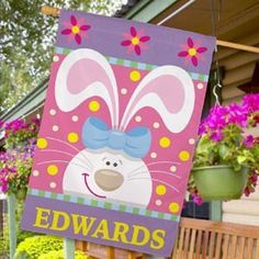 a sign that says edwards on it in front of some flowers