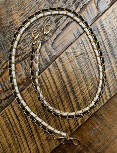 Lot of 2 Gold mask chains.  4.5mm gold curb chain  - one woven with white 3mm faux suede - one woven with black 3mm faux suede.  Overall length including clasps is approximately 26 inches which is a comfortable length for most people.  Lengths may vary slightly as chains are handmade.  They  have a great weight to them without feeling to heavy to wear all day.  Great gifts. Teacher gifts, shower favors, hostess gifts.  Many suede color choices available in my shop.  Custom bundles available. Just ask! Black And Gold Mask, Mask Chains, Gold Curb Chain, Female Mask, Gold Mask, Mask Chain, Gifts Teacher, Black Mask, Shower Favors