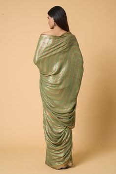 Pista saree with tonal and contrasting sequin embroidery in striped pattern. Comes with striped sequined unstitched blouse piece. - Aza Fashions Silk Floor-length Pre-draped Saree With Sequins, Floor-length Silk Pre-draped Saree With Sequins, Silk Sequined Floor-length Pre-draped Saree, Sequin Floor-length Silk Pre-draped Saree, Festival Silk Pre-draped Saree With Sequins, Semi-stitched Silk Saree With Sequins, Semi-stitched Silk Pre-draped Saree With Sequins, Navratri Silk Blouse Piece With Sequins, Silk Traditional Wear With Sequins