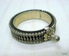 VINTAGE ANTIQUE GREAT DESIGN TRIBAL OLD SILVER HINGE BRACELET BANGLE (KAKAN) FROM RAJASTHAN INDIA. Silver guard bangles (Khatria or bangri gokru) with solid balls perimeters. Worn by DANGEE and PATEL tribal people of Rajasthan. One quarter-hinged part can be opened by central pin. Piece is good worn with a great antique look. See similar samples in” Traditional jewelry of India” by Oppi Untractht.Inner diameter - 4.7 cm(1.85") Outer diameter - 6 cm(2.36")Inner circumference - 14.7 cm(5.8")width Vintage Oxidized Finish Bangle For Festivals, Vintage Oxidized Finish Bracelets For Festivals, Vintage Oxidized Bangle For Festival, Vintage Oxidized Bracelets For Festivals, Antique Oxidized Finish Bracelet For Festival, Antique Metal Bangle For Festivals, Antique Metal Bangle For Festival, Festive Traditional Silver Beads Bracelets, Vintage Metal Bangle With Oxidized Finish