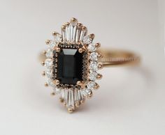 Vintage Black Onyx Starburst Engagement Ring, Art Deco Cluster Ring, Baguette Cut Black Onyx Ring, Antique Halo Wedding Ring, Ballerina Ring   ✥  Details ✥  - Stone: Gemstone / Moissanite/ Diamond/ CVD (Can Be Customize) - Metal Type: (White gold/ Yellow gold/ Rose gold, Sterling silver)  - Band Width: Approx. 1.5 MM - Cut: Emerald Cut - Center Stone Size:  MM - Clarity: VVS*/E-F  Ask For Quote if Required Real Diamond Ring   ✥ C U S T O M I Z A T I O N ✥  > The gemstone ring can be made of Morganite, Moissanite, Aquamarine, Emerald, Sapphire, Amethyst, Topaz, Tourmaline, Garnet, Ruby ETC. > For the marching band, I can custom-making the matching band according to your engagement ring, Let me know if you require this assistance.  > Ring can be personalized by diamond size and clarity. (exa Heidi Gibson, Telluride Wedding, Bijoux Art Deco, Black Onyx Engagement Ring, Halo Wedding Ring, Onyx Engagement Ring, Ring Baguette, Vintage Art Deco Rings, Emerald Cut Engagement