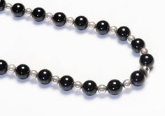 Tiffany & Co. Silver Onyx Bead Necklace.Vintage necklaces by Tiffany & Co. Length 28 inches. Onyx beads measuring 10 mm each. Signed Tiffany & Co. 925. Classic Onyx Necklace With Black Beads, Formal Onyx Necklace, Formal Onyx Round Bead Necklaces, Formal Onyx Necklace With Round Beads, Formal Onyx Beaded Necklaces With Polished Beads, Formal Onyx Beaded Necklace With Polished Beads, Classic Black Necklaces With 8mm Beads, Classic Black Round Beaded Jewelry, Formal Black Jewelry With Large Beads