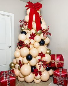 a christmas tree made out of balloons and presents