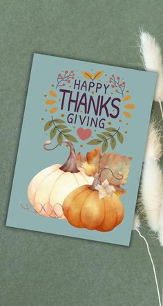 a card that says, happy thanksgiving giving with two pumpkins on top of it