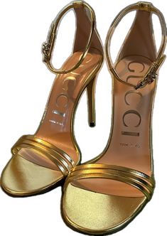 Designer Gold Ankle Strap Heels, Designer Gold Heels With 4-inch Heel, Elegant Gucci Sandals For Evening, Formal Gucci Sandals With Heel Strap, Gucci Formal Sandals With Heel Strap, Designer Ankle Strap Heels, Gucci Sandals With Heel Strap For Formal Occasions, Elegant Gold Gucci Heels, Designer Gold Closed Toe Sandals