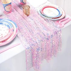 a table set with pink and blue plates