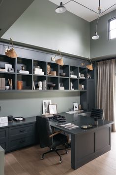 a home office with built - in bookcases and desk