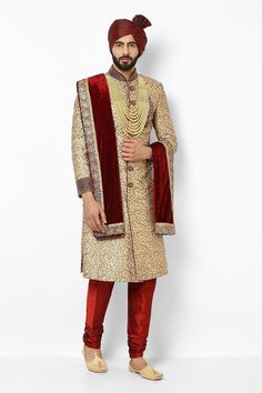 This item is made specially for you by hands with love  Item contains : Sherwani Pyjama Turban Stole  Mala & Shoes  Fabrics :   Brocade silk banaarsi  Colours :  Golden and maroon Style and Designs :  Sherwani has mandarin collar and long sleeves with a full button placket asymmetric hem and multiple slits  Embroidery with crystal beads hand embroidered motif on chest sleeves and sherwani and has embroidery work on collar and sleeves  Maroon solid churidar has a drawstring closure  Maroon turban Gold Sherwani With Zari Work For Groom, Gold Sherwani With Dabka For Groom, Gold Traditional Wear For Groom At Eid, Gold Traditional Wear For Groom At Diwali, Festive Gold Sherwani For Groom, Gold Groom's Traditional Wear For Diwali, Gold Kurta For Groom, Diwali Festival, Gold Kurta For Groom Diwali Occasion, Gold Kurta For Groom Diwali Celebration