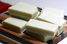 cubes of cheese sitting on top of a cutting board