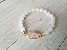 Gorgeous white stack features: -milky white with gold bead and spacers -matte white jade with matte gold hematite and gold spacers -white moonstone paired with a pink moonstone pendant. Pick one or all 3 of them. Choose your bracelet choice and your size from drop box. All your items will be packaged and shipped in a cotton filled kraft box. Adjustable White Crystal Bracelet With Gemstone Beads, White Spiritual Stretch Bracelet With Gemstone Beads, Spiritual White Gemstone Beads Stretch Bracelet, White Pearl Bracelet With Gemstone Beads For Spiritual Wear, White Spiritual Bracelets With Faceted Beads, White Spiritual Pearl Bracelet With Gemstone Beads, Spiritual White Pearl Bracelet With Gemstone Beads, White Hand-strung Crystal Bracelet, White Stretch Bracelet With Faceted Beads For Gift