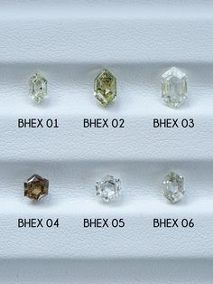 an assortment of different colored diamonds on display