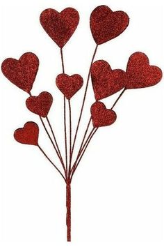 a bunch of red glitter hearts on top of a stick