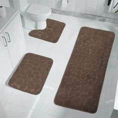 two bath mats on the floor in a bathroom