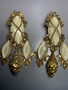 WONDERFUL ZOE COSTE PARIS Designer Clip On Vintage Dangly Earrings With Grey Crystal Glass Gold,Runway Statement 1980's iconic Byzantine Greek Couture Style. Amazing earrings with incredible detail, The top of the earring is the largest part, very decorated with leaves scrolled around the glass, a metal gold plated rope crossed over the cut glass stone, They have a very ornate baroque style and three dangly drops hanging down, as always with Zoe Coste even the back of the earrings are wonderful Antique Metal Earrings For Party, Vintage Single Earring For Party, White Costume Jewelry Earrings For Party, Vintage Metal Chandelier Earrings For Party, Vintage White Chandelier Earrings For Party, Vintage Plug Earrings For Party, Vintage Single White Earring, Vintage White Chandelier Earrings Gift, Vintage Single Clip-on Earring For Parties