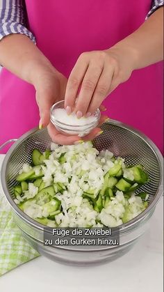 the woman is adding ingredients to her dish