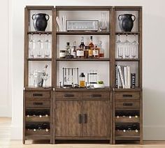 a wooden cabinet with bottles and glasses on it