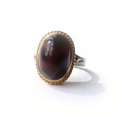 A beautiful vintage Tiger's Eye ring. This unique vintage ring features a large ploished Tiger's Eye cabochon set in a wonderful high profile solid silver gilt setting. The striking Tiger's Eye has a captivating depth and warmth to the gemstone, it is not easy to capture it's magic i a photograph.  A simply gorgeous vintage ring!  This ring comes with our very own Milly's Marvels gift box hand tied with Ribbon This ring is sizeable SIZE - US Size 6 3/4 / UK O WEIGHT - 4.4grams ERA - Circa 1970s Marvel Gifts, Unique Rings Vintage, Box Hand, Eye Ring, Tiger's Eye, Vintage Ring, Tiger Eye, Rings Statement, Unique Vintage