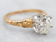 an antique diamond engagement ring in yellow gold