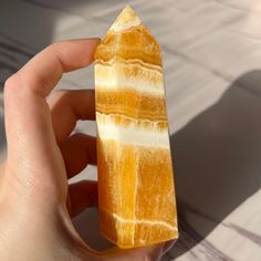 a person holding a piece of yellow stone