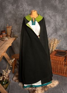 An oversized cloak is one of the most universal pieces of the medieval costume. A Cloak is made on a half-circle pattern, with a round neckline. The coat is wide enough that it can be easily wrapped around the body. The coat keeps you warm and is perfect for chilly evenings. It is a sign of high social status.  A length of a cloak is around 140 cm, the clasp doesn't come with cloak. The offer includes just wool cloak. ----------------------------------------------------------- FABRIC The materia Medieval Cape For Cosplay, Larp Cape For Halloween, Medieval Style Cape For Cosplay Events, Medieval Cape For Cosplay Events, Elven Style Cape For Costume Party, Elven Cape For Costume Party, Elven Style Cape For Medieval Festivals, Elven Cape For Medieval Festivals, Elven Cape For Cosplay And Medieval Festivals