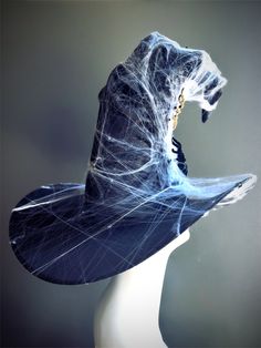 This bewitching headpiece features a classic witch hat design, draped in spiderwebs and spiders. Perfect for casting spells at Halloween parties, haunted houses, or any spooky celebration, this hat will ensure you make a spine-tingling entrance. Age Group/Gender - Adult/Women Size/Type - One size fits all adults Color - Black Special Features - velvet Spiders and webs Spooky Halloween Costume Hats And Headpieces, Spooky Hats For Halloween Costume Party, Gothic Wide Brim Costume Hats For Halloween, Gothic Wide Brim Halloween Costume Hats, Witchy Halloween Costume Hats And Headpieces For Themed Events, Witchy Halloween Costume Accessories With Curved Brim, Witch Hat Design, Mardi Gras Kid, Kids Party Packs