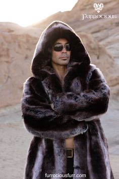 Elegant and stylish, this men's truffle brown hooded playa coat is the perfect addition to any festival fashion ensemble. Made with exclusive French Tissavel faux fur, this coat is not only silky soft but also thick and luxurious, ensuring both warmth and sophistication. Ideal for male fashion enthusiasts looking to make a statement at any event.  SHOP NOW! @ furrociousfurr.com. | Men's Fashion | Festival Style | Luxury Coat | French Faux Fur Luxury Hooded Faux Fur Outerwear, Luxury Faux Fur Outerwear In Mink Color, Luxury Faux Fur Coat For Cold Weather, Mink Faux Fur Coat With Faux Fur Lining, Mink Colored Faux Fur Coat, Fluffy Mink Hooded Fur Coat, Festival Fashion Men, Mens Festival Fashion, Winter Coat Snow