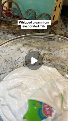 a bowl filled with whipped cream on top of a counter