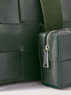 Bottega Veneta's 'Casette' bag is such a hit that the house now offers it in a range of colours and sizes. This one has been crafted in Italy from durable leather and woven in the label's distinctive intrecciato pattern. The sleek, understated profile will work with formal and casual outfits. Square Shoulder Bag With Intrecciato Weave For Travel, Luxury Pouch Box Bag With Leather Handles, Luxury Woven Leather Square Shoulder Bag, Luxury Square Woven Leather Shoulder Bag, Square Leather Bag With Intrecciato Weave, Leather Square Bag With Intrecciato Weave, Rectangular Satchel With Intrecciato Weave For Travel, Travel Rectangular Satchel With Intrecciato Weave, Designer Square Briefcase With Removable Pouch