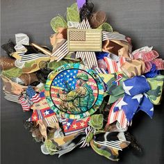 a wreath made out of various flags and ribbons