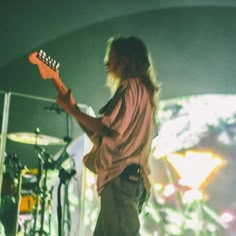 a man playing an electric guitar on stage