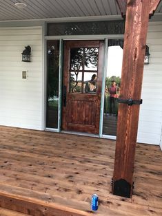 a wooden porch with steps leading to the front door