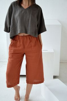 "Terracotta culottes linen pants for woman. Short loose pants with pockets. Choose size: XS Waist 66 - 68 cm. / (26\" - 26 3/4\") Hips 90 - 92 cm. / (35 1/2\" - 36 1/4\") S Waist 70 - 72 cm. / (27 3/4\" - 28 1/4\") Hips 94 - 96 cm. / (37\" - 37 3/4\") M Waist 74 - 76cm. / (29 1/4\" - 30\") Hips 98 - 100 cm. / (38 1/2\" - 39 1/4\") L Waist 78 - 80 cm. / (30 3/4\" - 31 1/2\") Hips 102 - 104 cm. / (40 1/4\" - 41\") XL Waist 82 - 84 cm. / (32 1/4\" - 33\") Hips 106 - 108 cm. / (41 3/4\" - 42 1/2\") Casual Wide Leg Linen Capris, Casual Linen Culottes With Loosely Fitted Hips, Wide Leg Flax Bottoms With Pockets, Casual Linen Culottes With Pockets, Wide Leg Linen Capris For Summer, Linen Cropped Leg Capris For Summer, Linen Summer Capris With Cropped Leg, Spring Linen Wide Leg Capris, Summer Linen Cropped Leg Capris