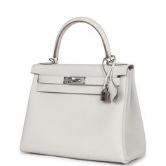 This Kelly 28, in the Retourne style, is in Gris Pale togo leather with palladium hardware and has tonal stitching, front flap with two straps, front toggle closure, clochette with lock and two keys, and single rolled handle.The interior is lined in Gris Pale chevre leather.Collection: BOrigin: FranceCondition: New and never worn (plastic on hardware)Accompanied by: Hermes box, Hermes dustbag, lock, 2 keys, clochette, clochette dustbag, strap, strap dustbag, felt, rainhat, carebook and ribbonMeasurements: 11.25" width x 8.25" height x 4.75" depth; 3.5" handle drop (16.5" shoulder strap drop) Elegant Togo Leather Textured Bag, Classic Togo Leather Bag With Silver-tone Hardware, Luxury Togo Leather Formal Bag, Formal Calf Leather Bag With Lock, Classic Togo Leather Bag With Leather Lining, Classic Bags With Togo Leather And Leather Lining, Timeless Togo Leather Bag With Leather Lining, Classic Formal Bags In Togo Leather, Formal Togo Leather Bags