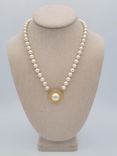 Vintage White Single Strand Faux Pearls with Round Gold Tone Pendant Necklace This vintage necklace makes a great statement piece.  A single strand of white faux pearl beads is accented with a beautiful gold-tone & faux pearl round pendant.  The 19 1/2" long necklace secures with a spring-ring clasp.  This piece is in excellent, nearly new condition.   Dimensions: 19 1/2" length  Clasp: Spring Ring Markings: None Condition: Excellent - nearly new All of my shop items are pre-owned vintage.  All Luxury Vintage White Beaded Necklace, Cream Pearl Necklace With Pearl Charm, Cream Pearl Pendant Necklace, Costume Jewelry Pearl Necklace With Pearl Pendant, Cream Pearl Drop Necklaces With Round Beads, Cream Pearl Drop Necklace With Round Beads, Single Strand Pearl Necklace Costume Jewelry, Single Strand Pearl Costume Jewelry Necklace, Single Strand Pearl Necklace For Costume Jewelry