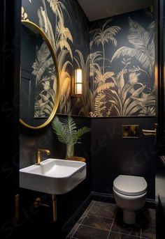 a bathroom with black and gold wallpaper, a white toilet and a sink in it