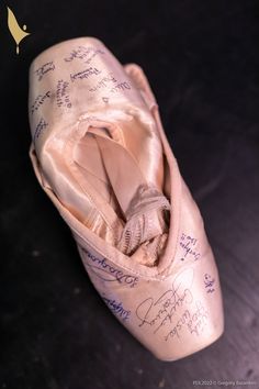 a ballerina's shoe with autographed notes on the inside and bottom