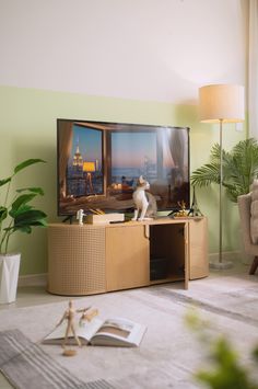 a cat sitting on top of a table in front of a tv