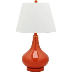 an orange table lamp with a white shade